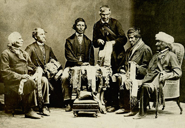 Original title:    Description English: Chiefs of the Six Nations at Brantford, Canada, explaining their wampum belts to Horatio Hale September 14, 1871. Image shows Joseph Snow (Hahriron), Onondaga Chief;George H. M. Johnson (Deyonhehgon), Mohawk chief, Government interpreter and son of John Smoke Johnson; John Buck (Skanawatih), Onondaga chief, hereditary keeper of the wampum; John Smoke Johnson (Sakayenkwaraton), Mohawk chief, speaker of the council; Isaac Hill (Kawenenseronton), Onondaga chief, fire keeper; John Seneca Johnson (Kanonkeredawih), Seneca chief. Hale inscribed these photographs, which he sent to colleagues, 