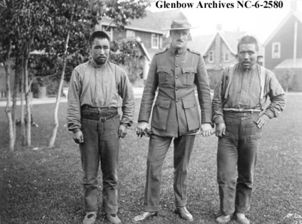 Original title:    Description English: Sinnisiak (left), Inspector Denny LaNauze (centre), Uloqsaq (right). Public domain Public domain  This Canadian work is in the public domain in Canada because its copyright has expired due to one of the following: 1. it was subject to Crown copyright and was first published more than 50 years ago, or it was not subject to Crown copyright, and 2. it is a photograph that was created prior to January 1, 1949, or 3. the creator died more than 50 years ago. Česky | Deutsch | English | Español | Suomi | Français | Italiano | Македонски | Português | +/− Date August 1917 Source GLENBOW ARCHIVES