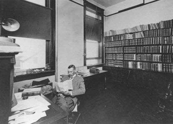 Original title:  Photograph of J.C.F. Bown seated at desk in his law office. Annotated on back: 